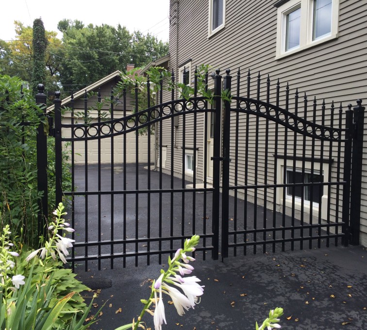 Residential swing gate opening on a flat driveway