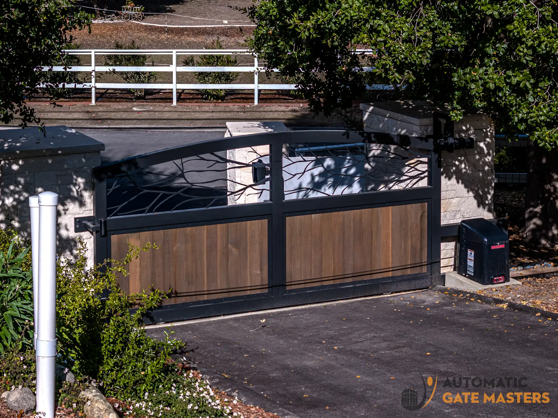Custom sliding driveway gate with laser cut branch panel in Los Altos Hills