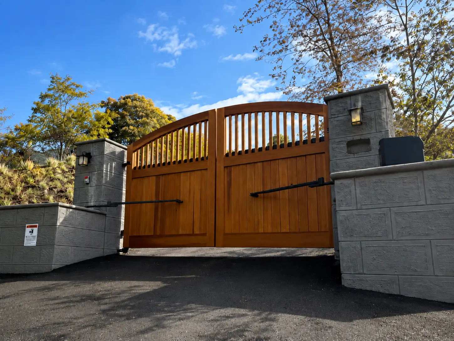 Cedar swing gate hung between masonry columns in San Rafael
